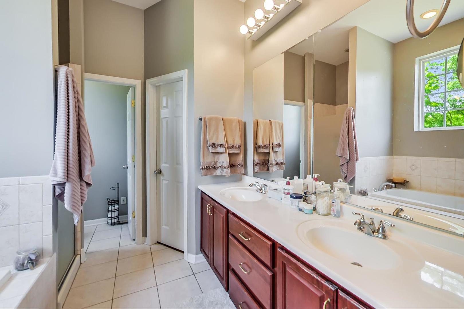 2101 Bull Ridge Drive McHenry, IL 60050 - Photo 26 of 83 a spacious bathroom with a double vanity sink a mirror and a shower