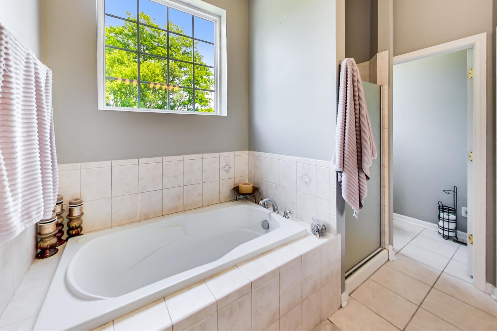 2101 Bull Ridge Drive McHenry, IL 60050 - Photo 27 of 83 a bathroom with a tub and a shower