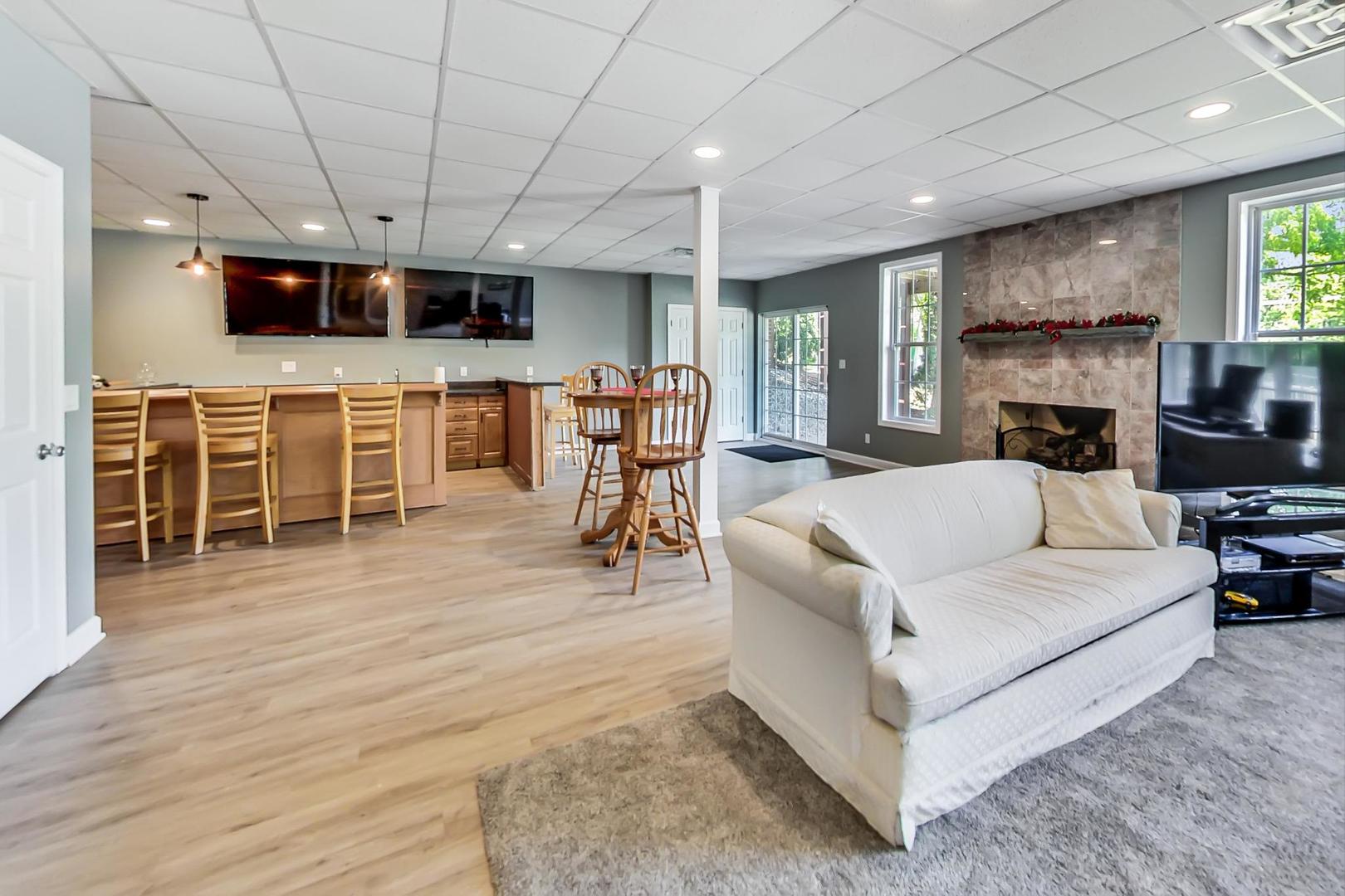 2101 Bull Ridge Drive McHenry, IL 60050 - Photo 49 of 83 a living room with furniture a flat screen tv and kitchen view
