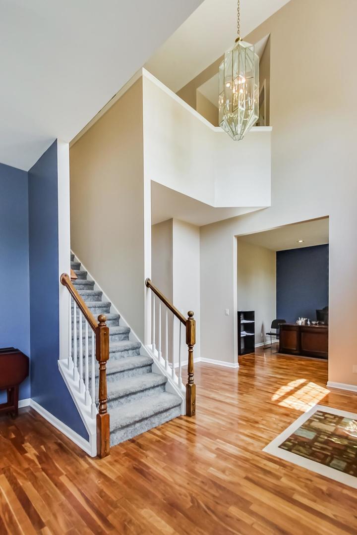 2101 Bull Ridge Drive McHenry, IL 60050 - Photo 7 of 83 a view of a livingroom with wooden floor and stairs