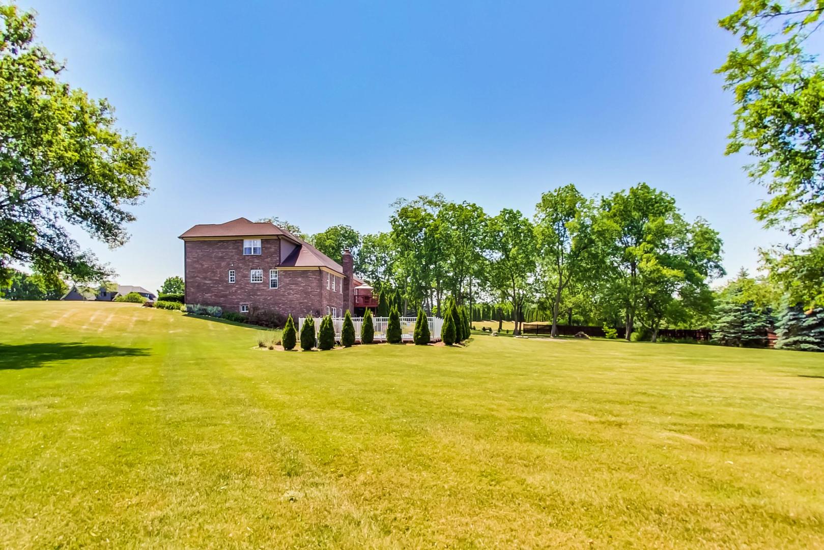 2101 Bull Ridge Drive McHenry, IL 60050 - Photo 77 of 83 a view of a swimming pool with an outdoor space and seating area