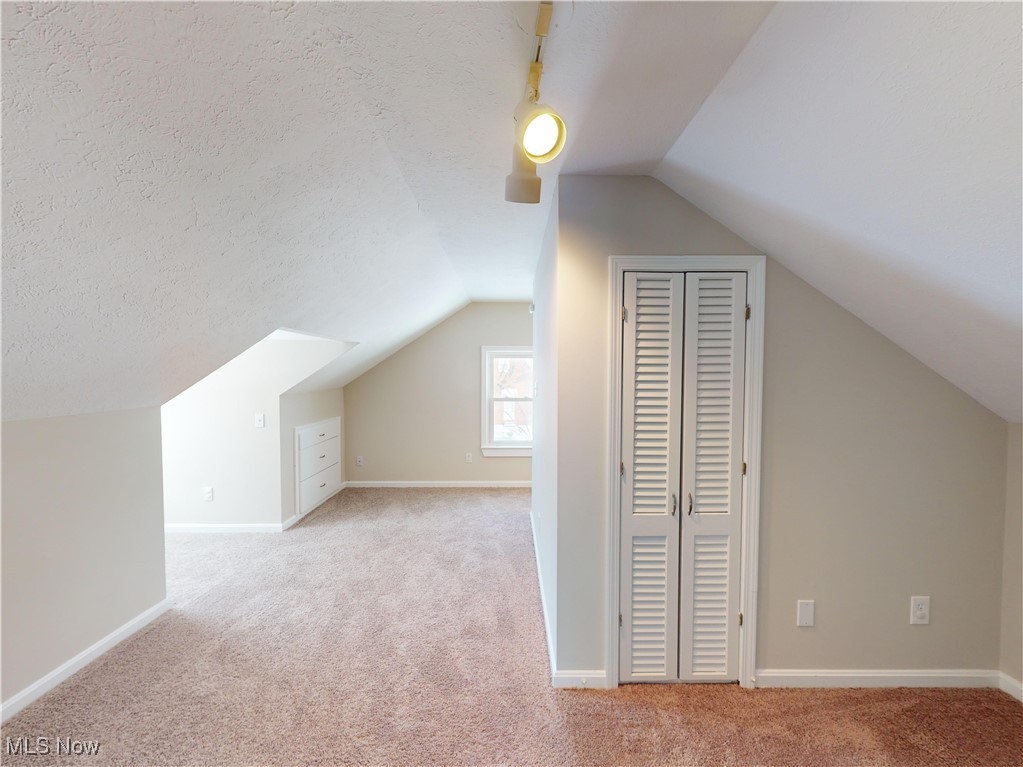 1343 Irene Road Lyndhurst, OH 44124 - Photo 20 of 32 Bonus room featuring lofted ceiling, light carpet, and a textured ceiling