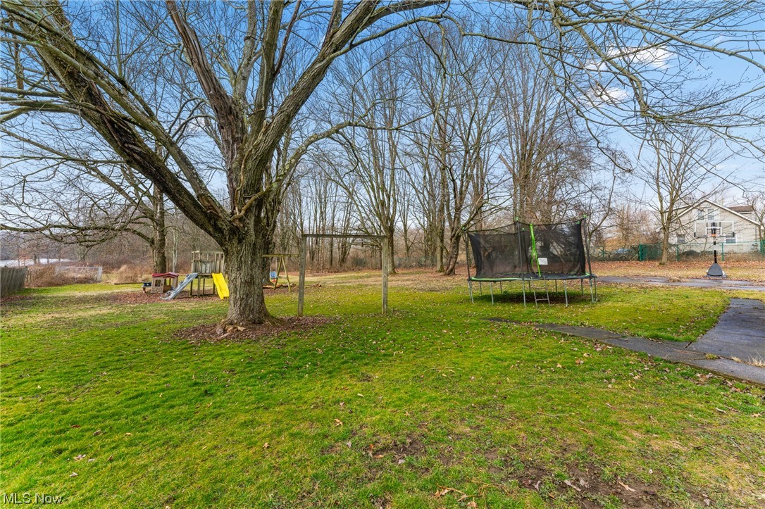 1470 Collar Price Road Hubbard, OH 44425 - Photo 22 of 23 View of yard featuring a playground and a trampoline