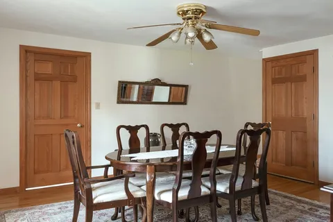 a view of a dining room with furniture and chandelier