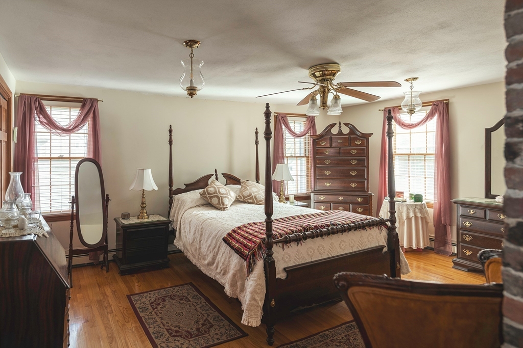21-23 East Main Street Merrimac, MA 01860 - Photo 23 of 31 a bedroom with bed or furniture and a chandelier