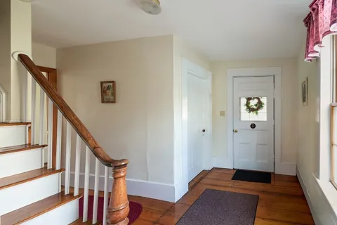 a view of an entryway with wooden floor and stairs
