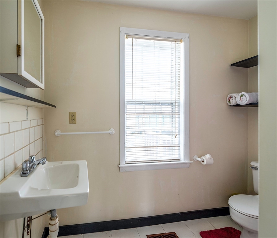 21-23 East Main Street Merrimac, MA 01860 - Photo 7 of 31 a bathroom with a sink a toilet and a window
