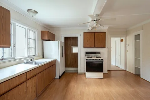 a kitchen with stainless steel appliances granite countertop a refrigerator and a stove top oven