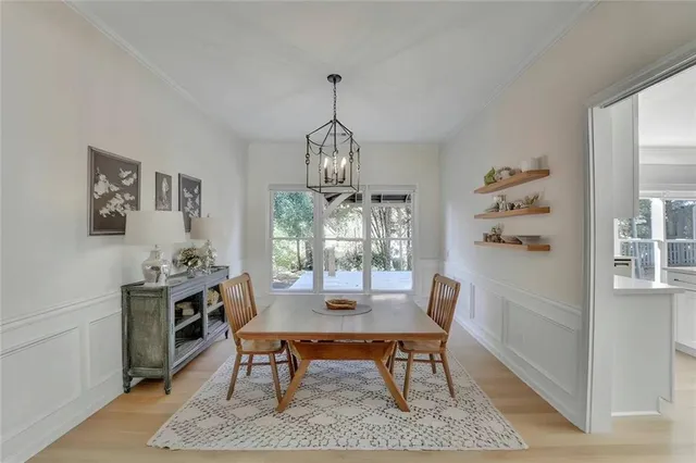 a dining room with furniture a rug and a chandelier
