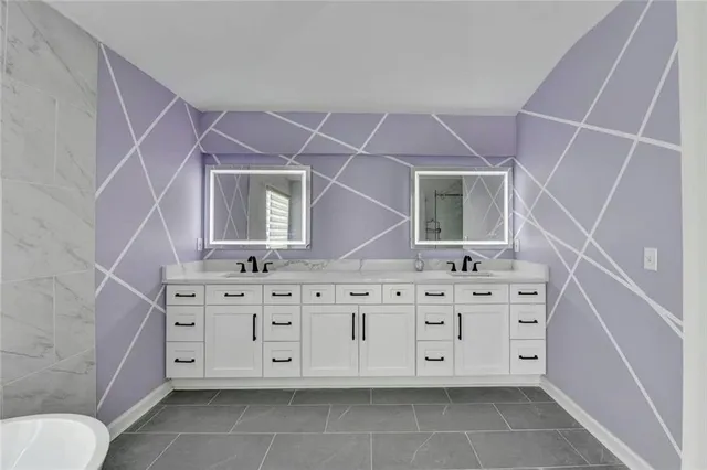 a bathroom with a granite countertop sink a mirror and a toilet