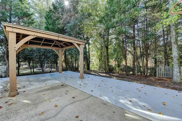 a view of a dirt road with a large tree
