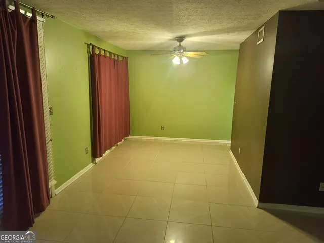 a view of an empty room with a mirror