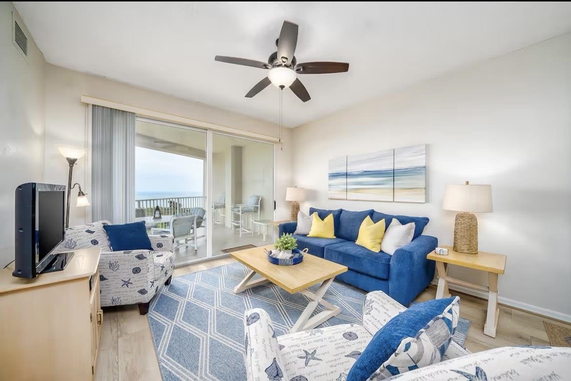104 Surfview Drive, Unit 1307 Palm Coast, FL 32137 - Photo 11 of 17 a living room with furniture and a flat screen tv