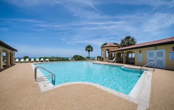 a view of swimming pool with a yard and seating area
