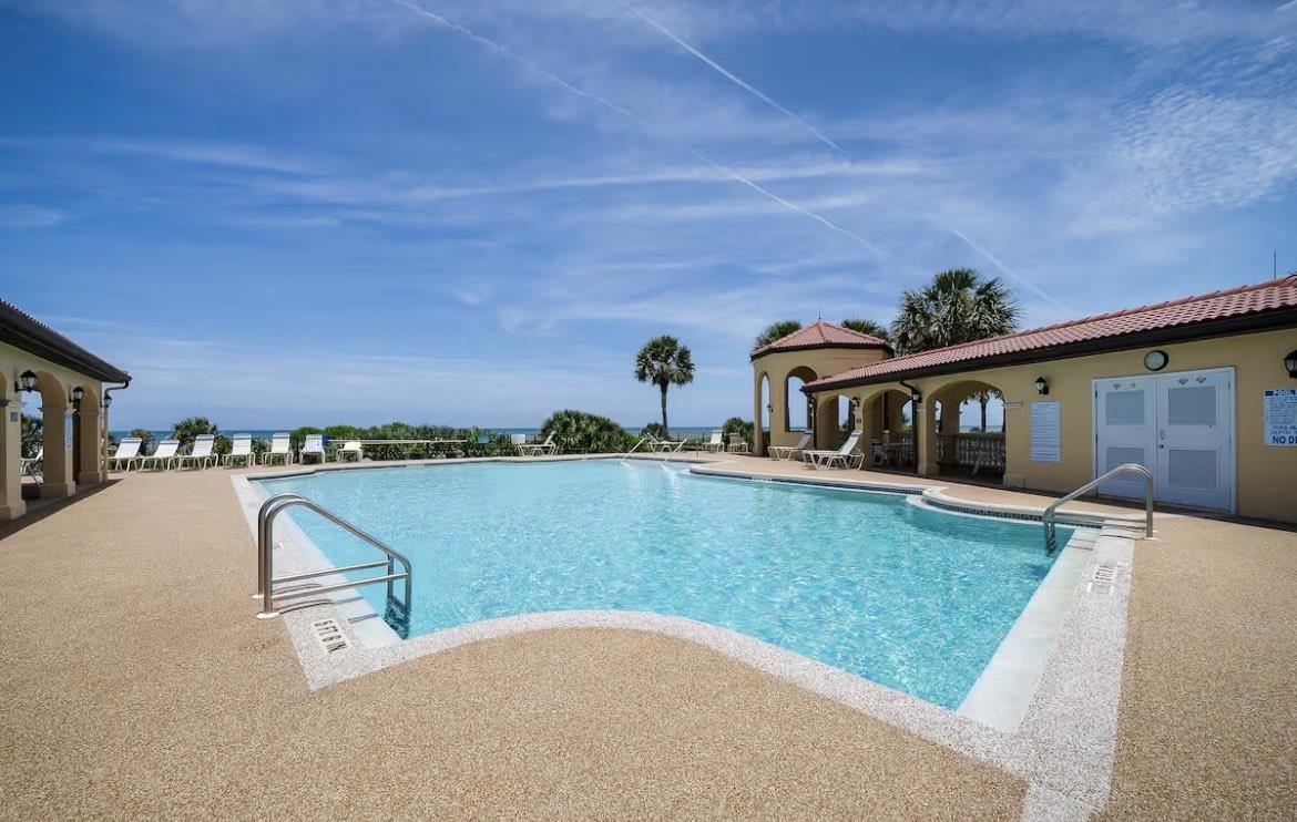104 Surfview Drive, Unit 1307 Palm Coast, FL 32137 - Photo 13 of 17 a view of swimming pool with a yard and seating area
