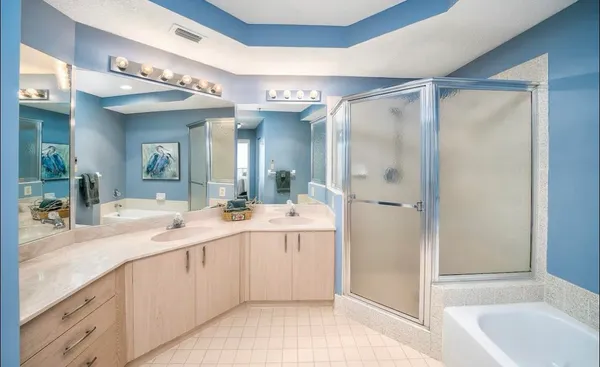 a spacious bathroom with a shower sink vanity and mirror