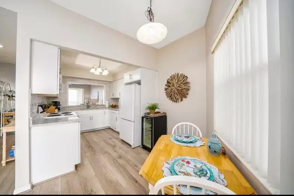 a kitchen with stainless steel appliances granite countertop a stove a sink dishwasher and a microwave with wooden floor