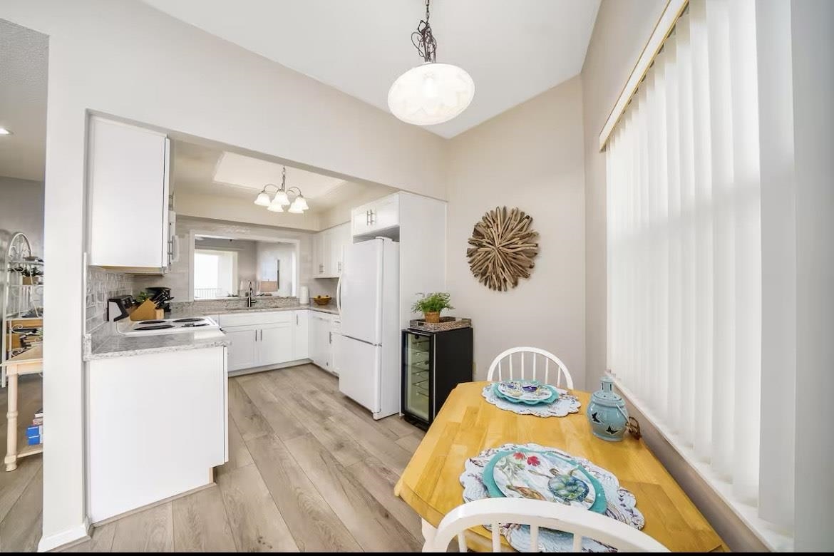 104 Surfview Drive, Unit 1307 Palm Coast, FL 32137 - Photo 8 of 17 a kitchen with stainless steel appliances granite countertop a stove a sink dishwasher and a microwave with wooden floor