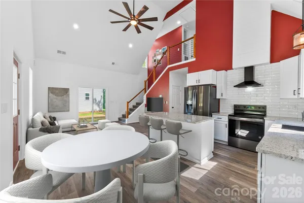 a view of a kitchen with furniture and a ceiling fan