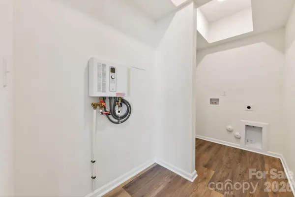 an empty room with chandelier fan and windows