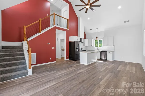 a view of a big room with wooden floor and bench