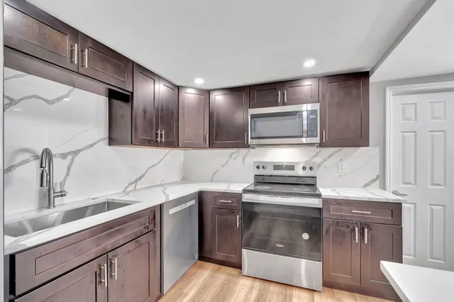 a kitchen with granite countertop a stove and a sink