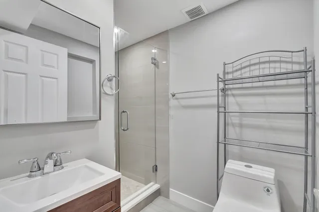 a bathroom with a sink toilet and shower