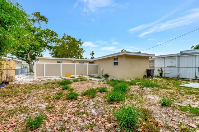 a view of backyard of house and car parked
