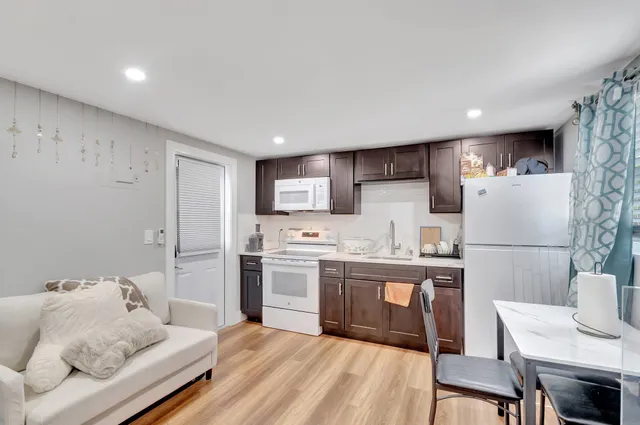 a kitchen with a refrigerator and a table