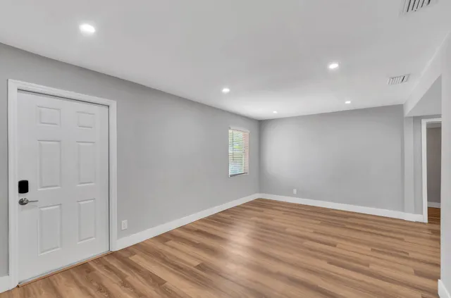 wooden floor in an empty room with a window