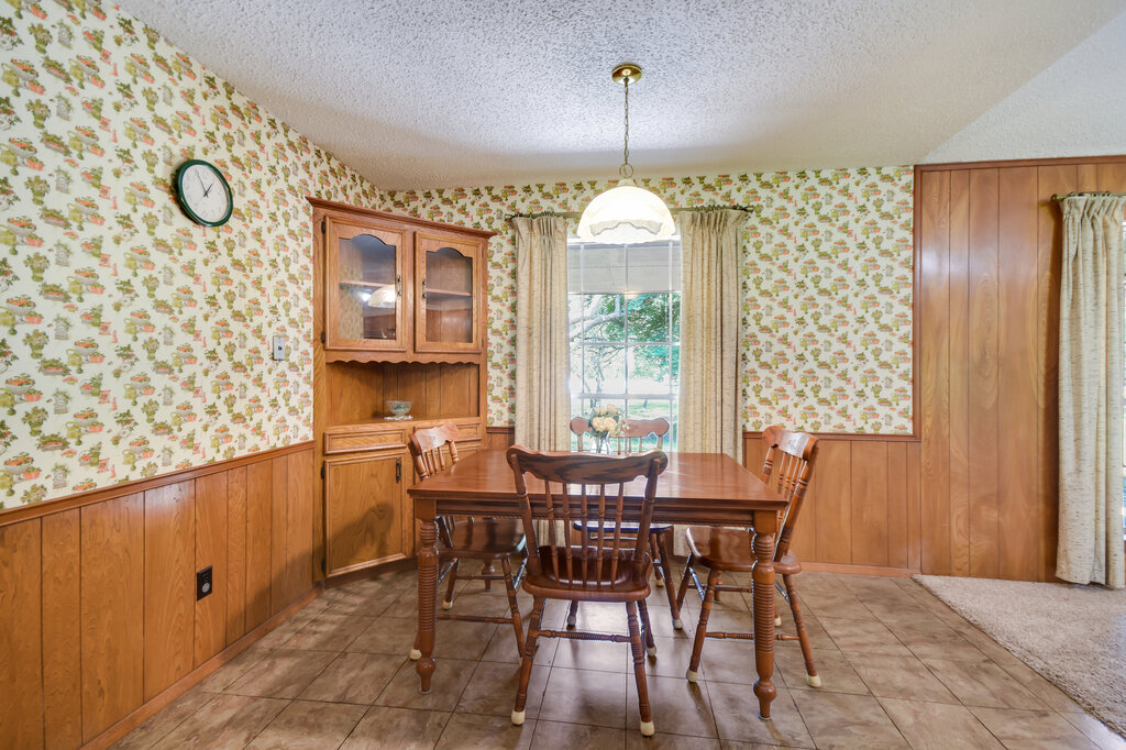 301 Navajo Trail Georgetown, TX 78633 - Photo 22 of 35 Dining space with wallpapered walls, a wainscoted wall, and a textured ceiling
