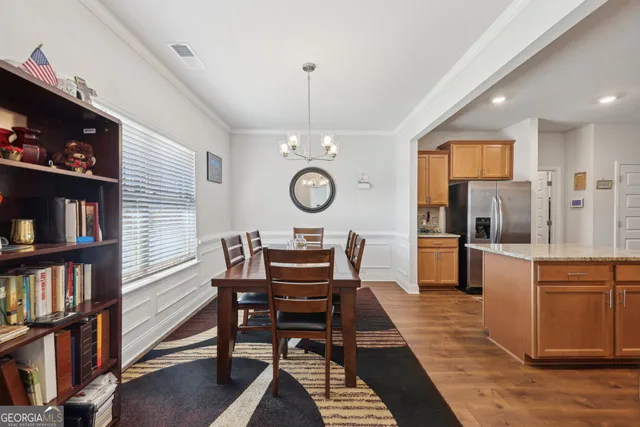 a dining room with furniture and a book shelf