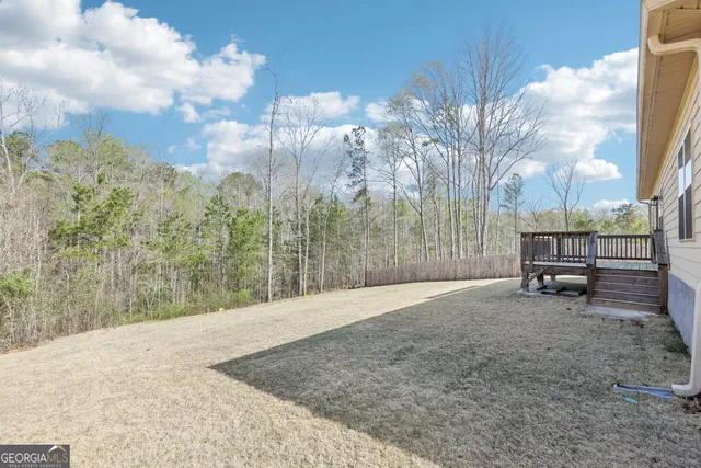 a backyard of a house with table and chairs