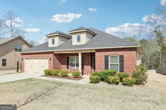 a front view of a house with garden