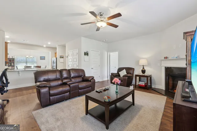 a living room with furniture a fireplace and a flat screen tv