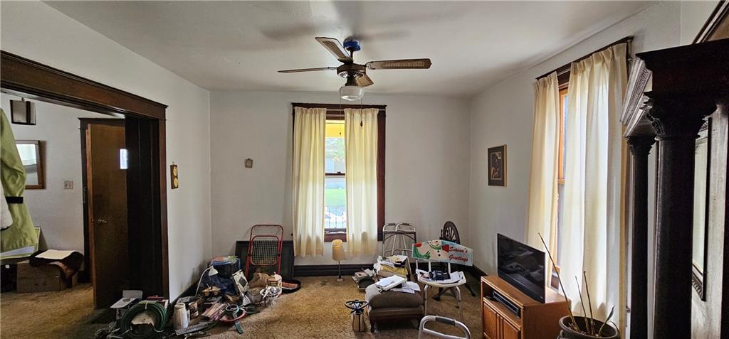 417 Uber Street New Castle, PA 16101 - Photo 6 of 43 a room with furniture a chandelier fan and a window