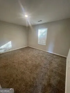 an empty room with a empty space and windows