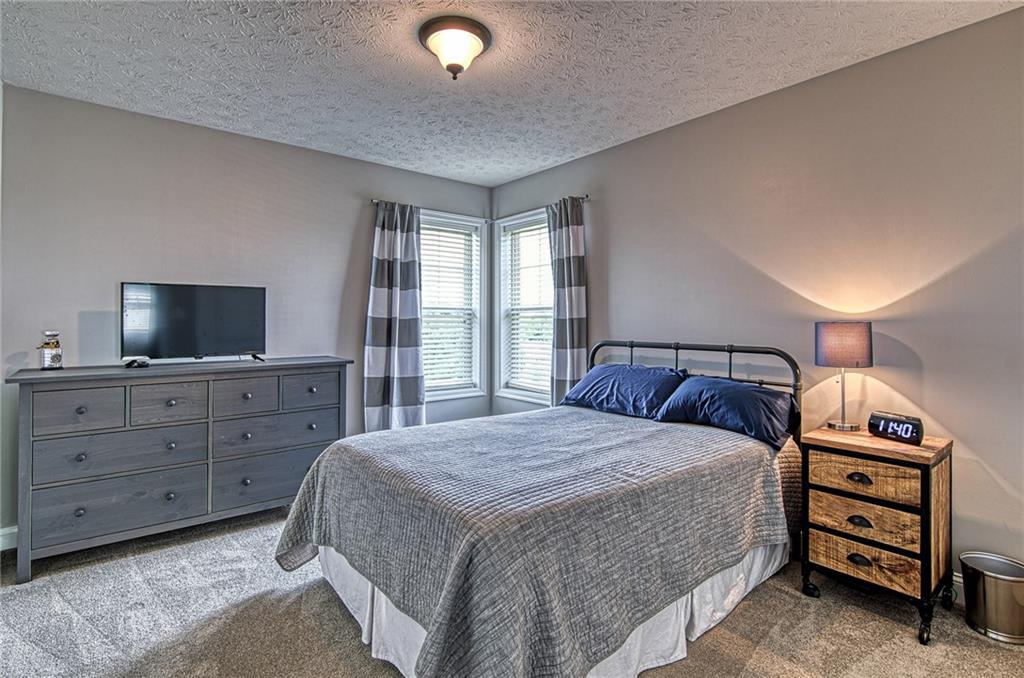 108 Seaton Crest Drive Mars, PA 16046 - Photo 16 of 25 a bedroom with a bed and a flat screen tv