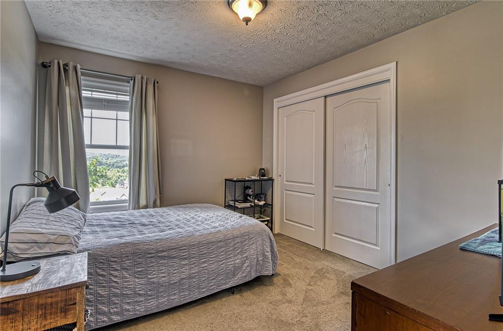 108 Seaton Crest Drive Mars, PA 16046 - Photo 17 of 25 a bedroom with a bed and large windows