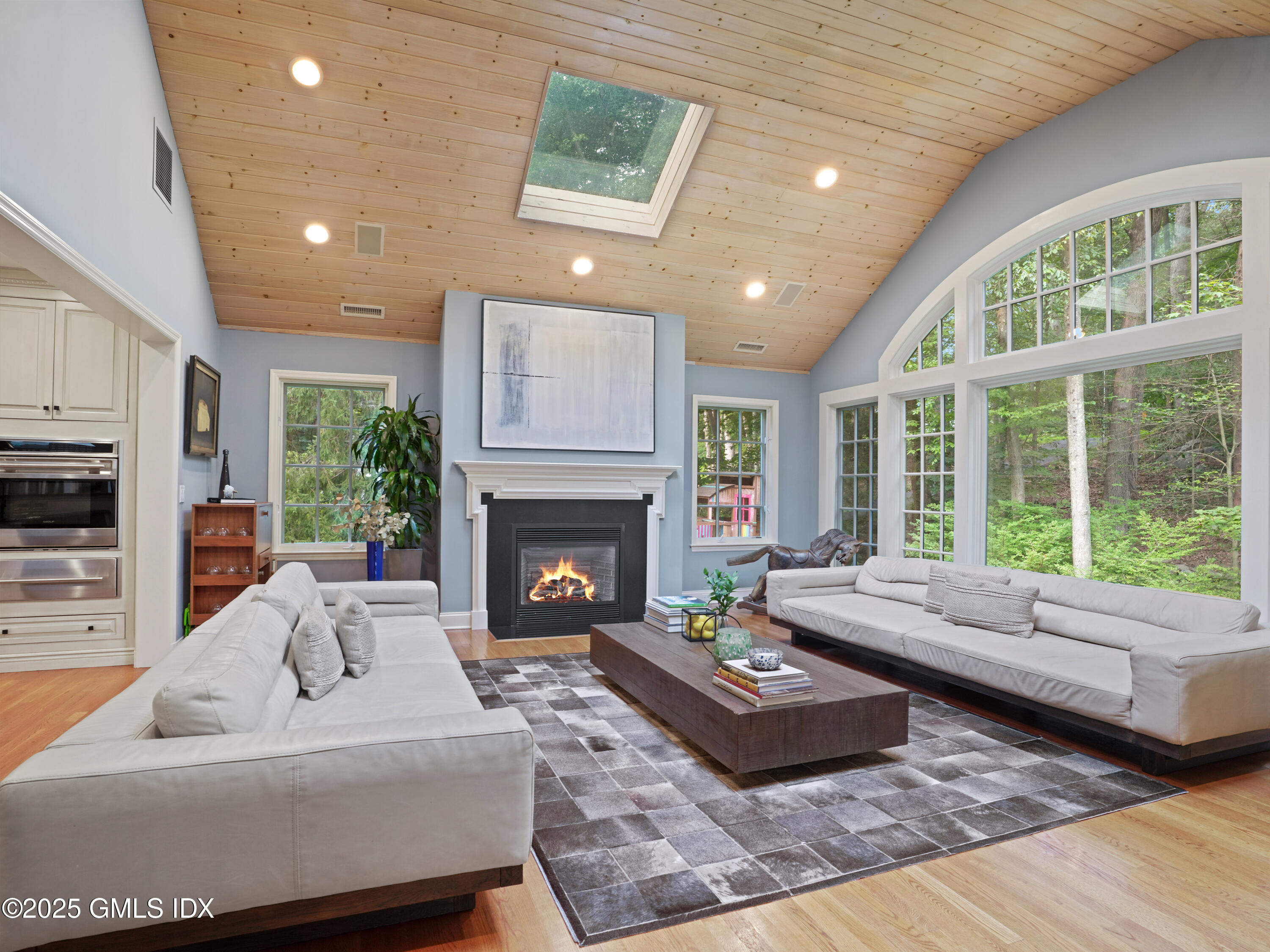 25 Jeffrey Road Greenwich, CT 06830 - Photo 12 of 35 a living room with furniture large window and a fireplace