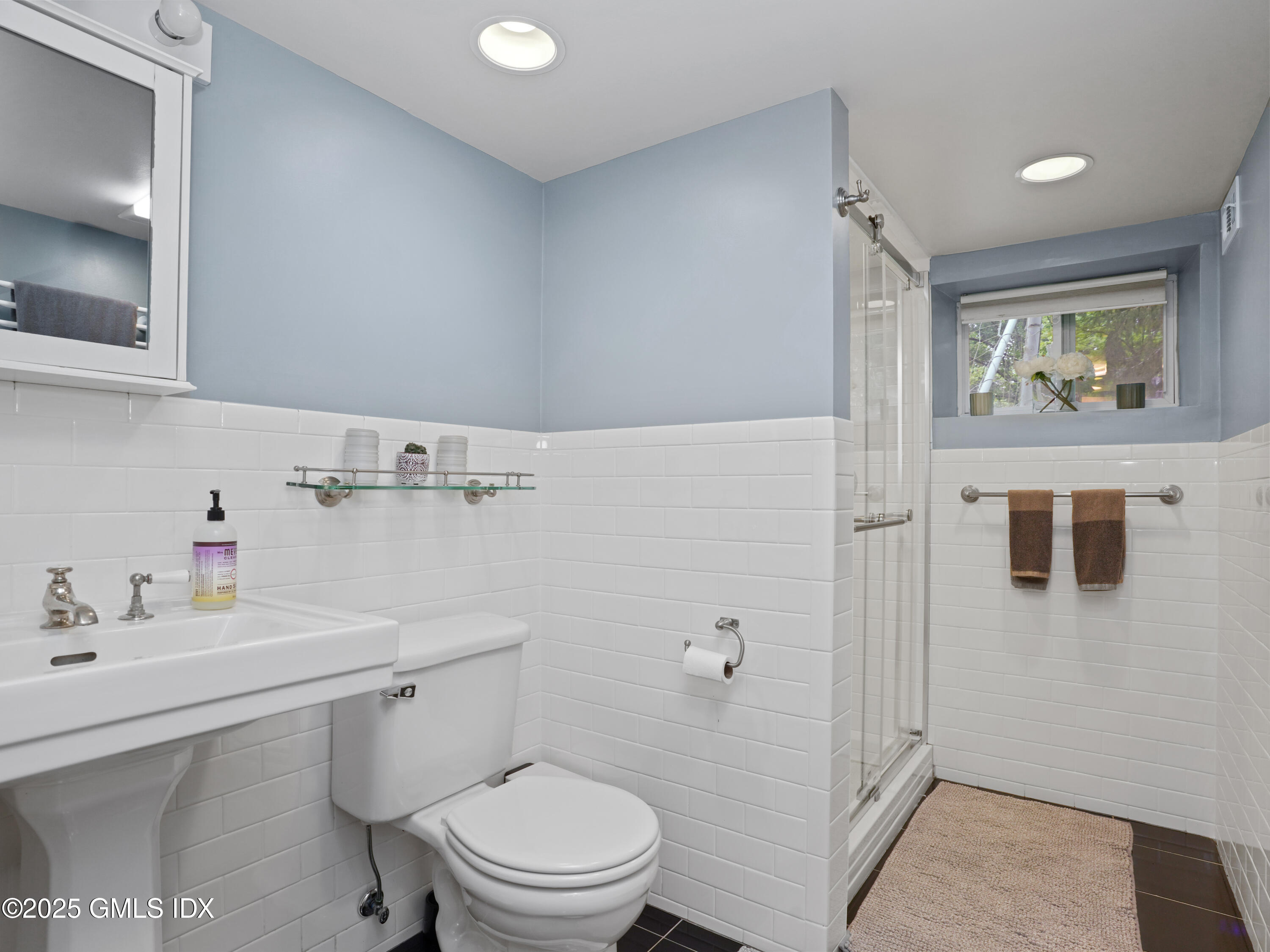 25 Jeffrey Road Greenwich, CT 06830 - Photo 27 of 35 a bathroom with a sink a toilet and shower