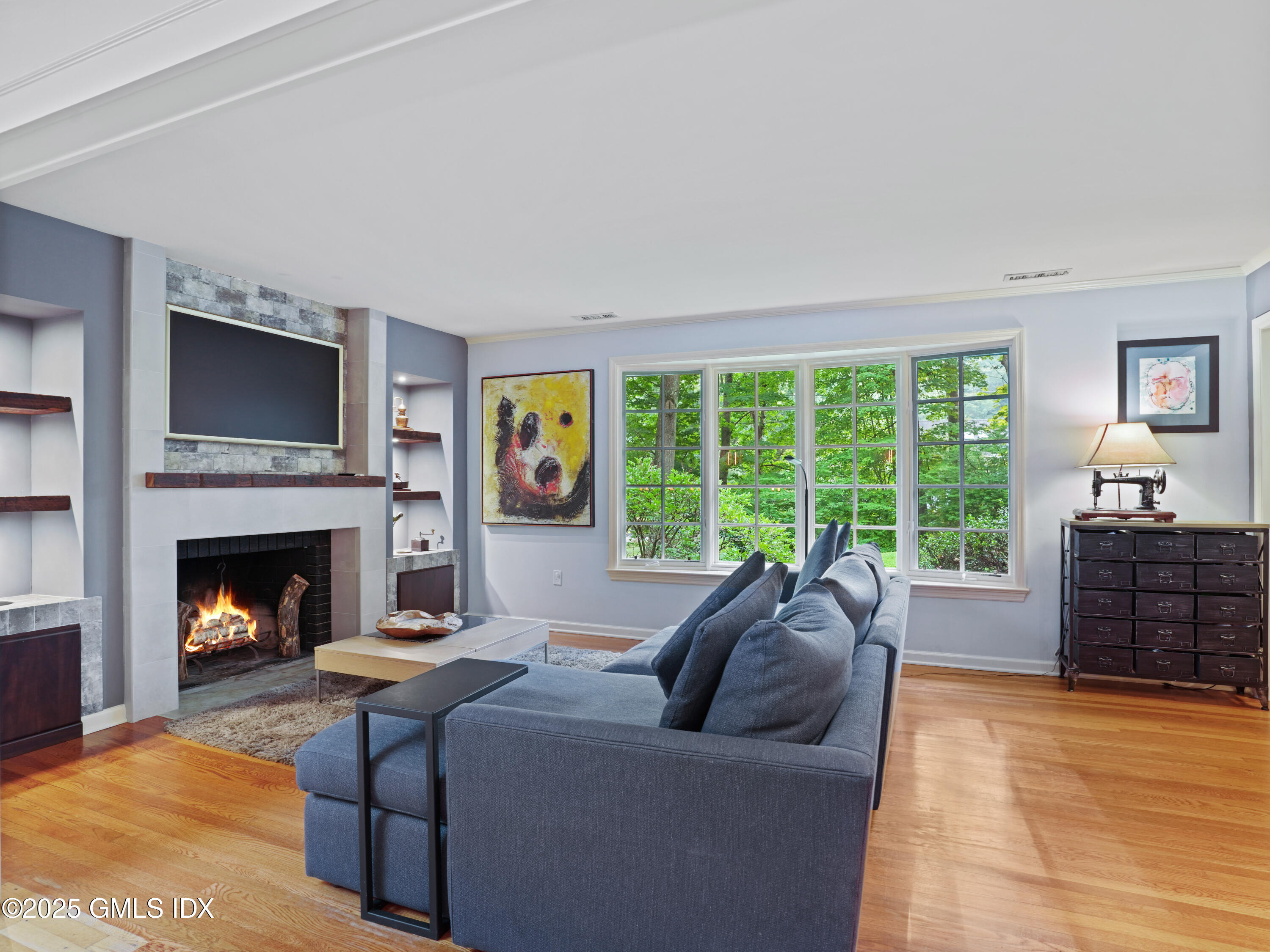 25 Jeffrey Road Greenwich, CT 06830 - Photo 3 of 35 a living room with furniture a flat screen tv and a fireplace