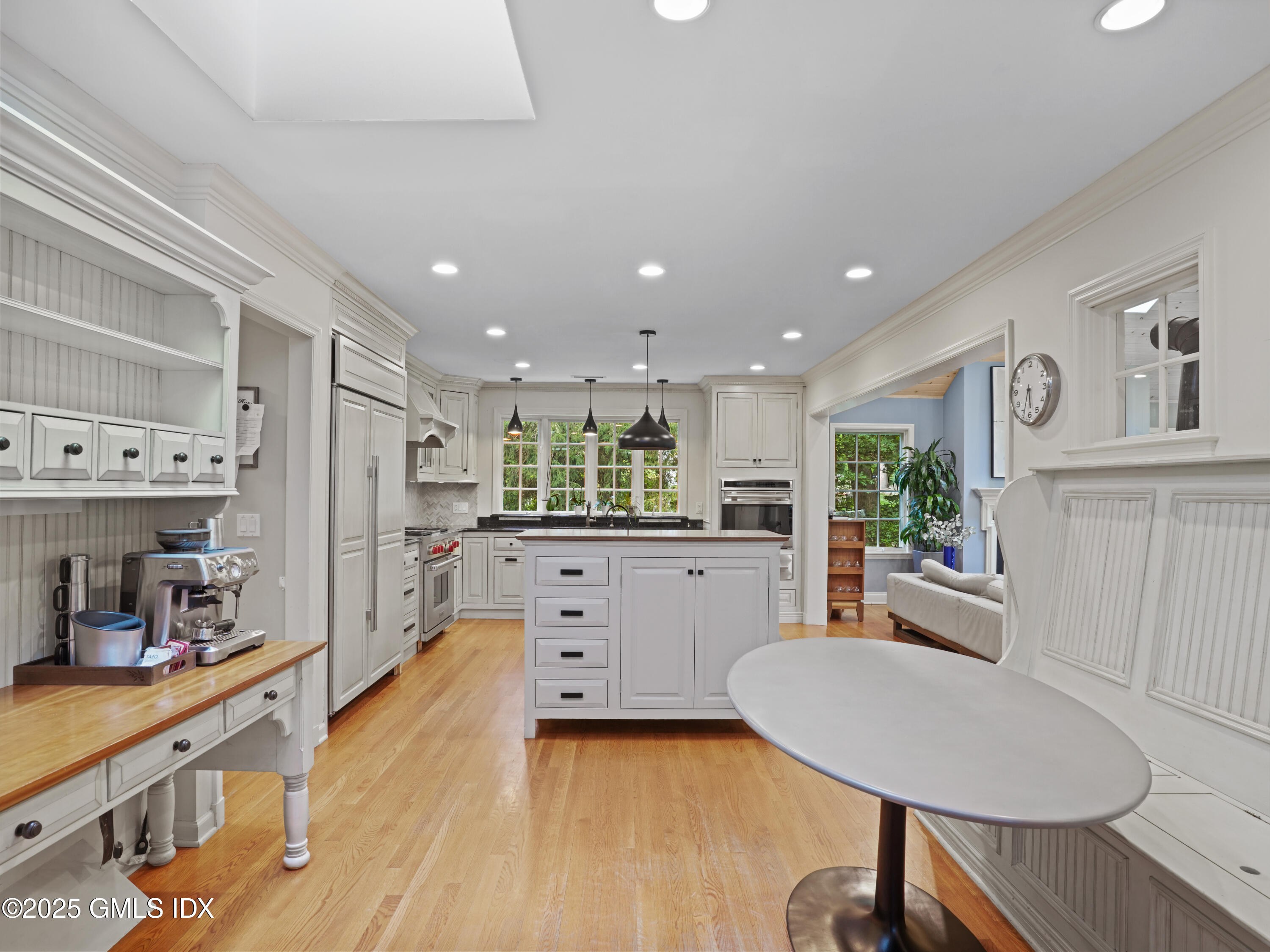 25 Jeffrey Road Greenwich, CT 06830 - Photo 7 of 35 a kitchen with stainless steel appliances kitchen island hardwood floor sink and cabinets