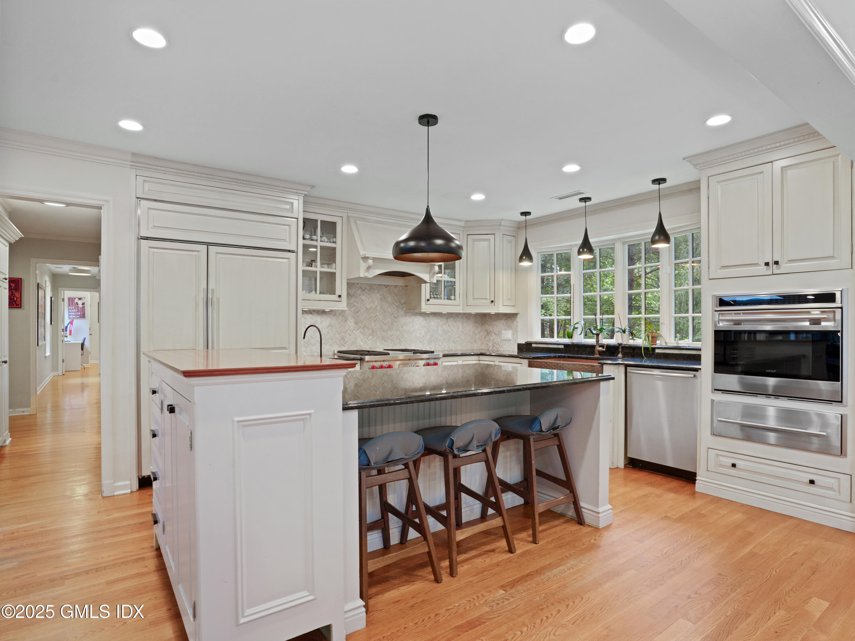 25 Jeffrey Road Greenwich, CT 06830 - Photo 9 of 35 a kitchen with kitchen island granite countertop a stove a sink a refrigerator and a cabinets