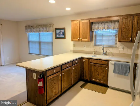 a kitchen with stainless steel appliances a refrigerator sink and cabinets