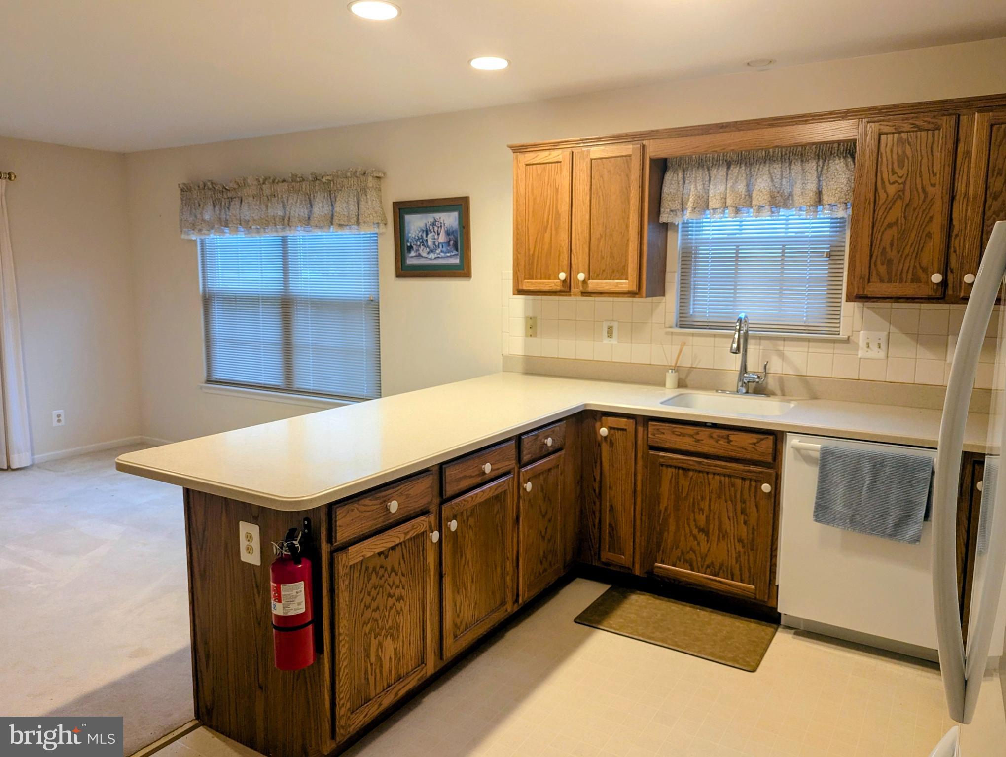 415 Country Way Mickleton, NJ 08056 - Photo 13 of 26 a kitchen with a sink a stove cabinets and a window