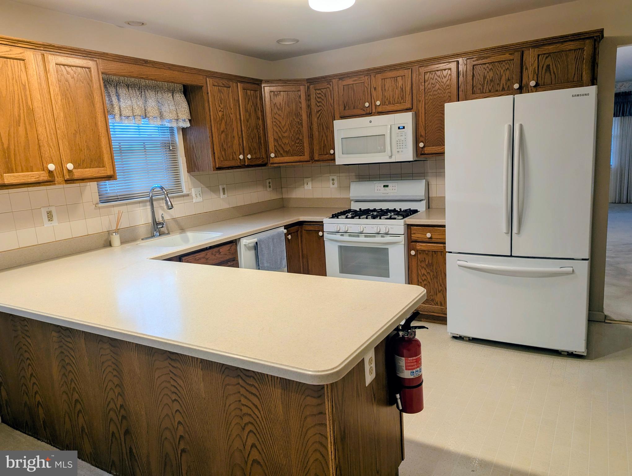 415 Country Way Mickleton, NJ 08056 - Photo 14 of 26 a kitchen with stainless steel appliances a refrigerator sink and cabinets
