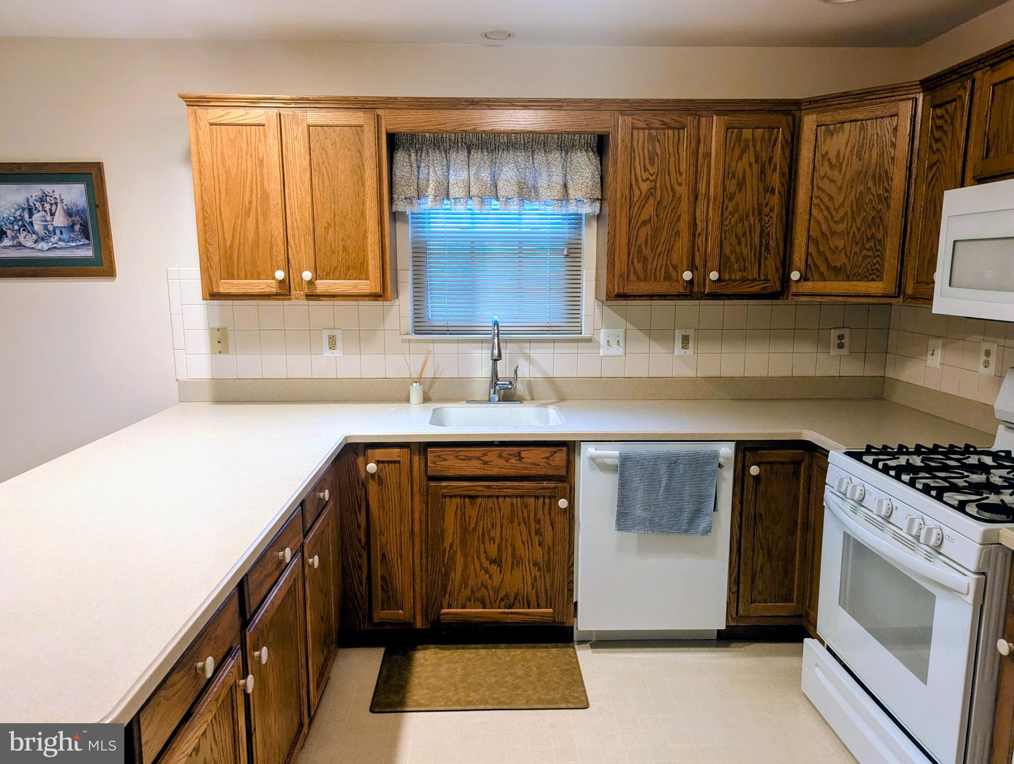 415 Country Way Mickleton, NJ 08056 - Photo 16 of 26 a kitchen with a sink stove and cabinets