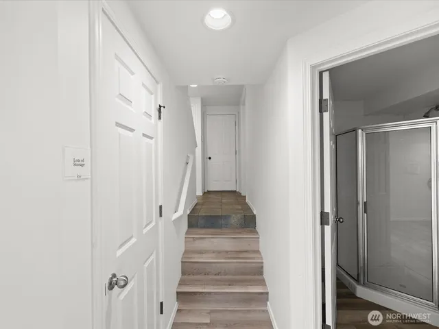 a view of a hallway with wooden floor and entryway