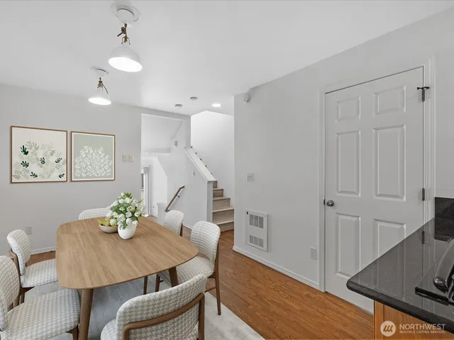 a view of a dining room with furniture and wooden floor